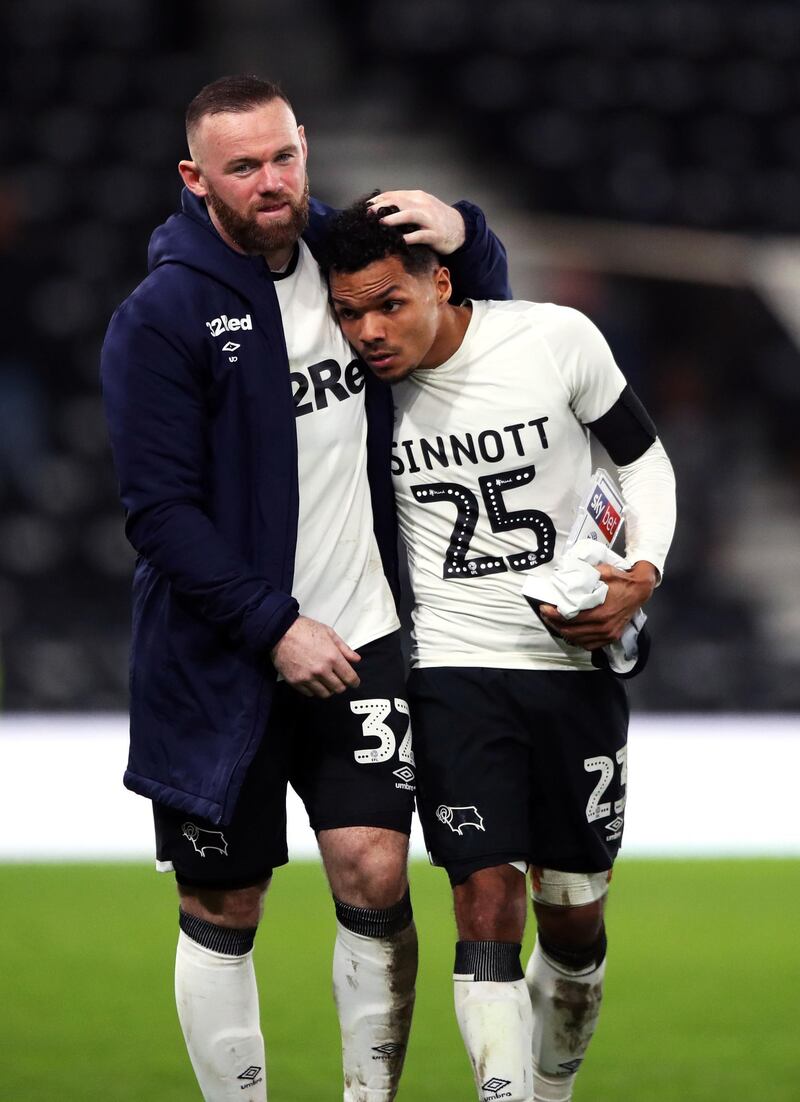 Wayne Rooney with Duane Holmes after the match. PA