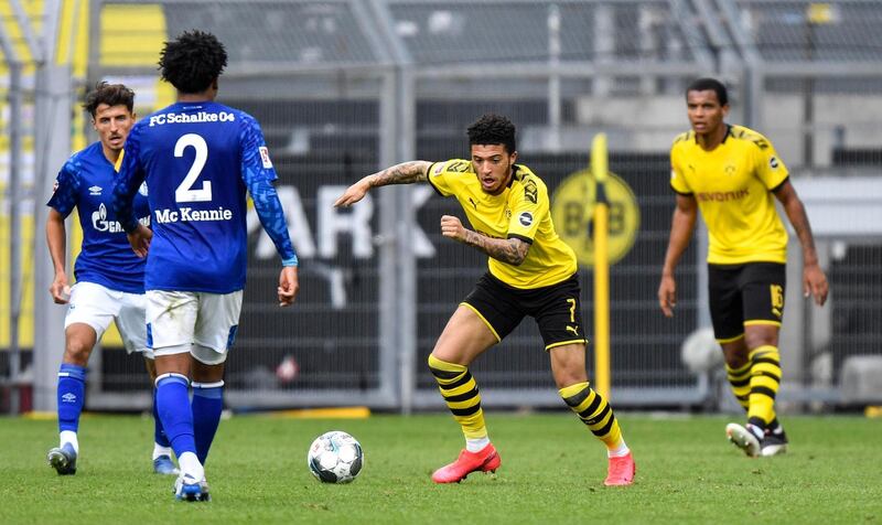 Jadon Sancho chases the ball down during a game against Schalke. AFP