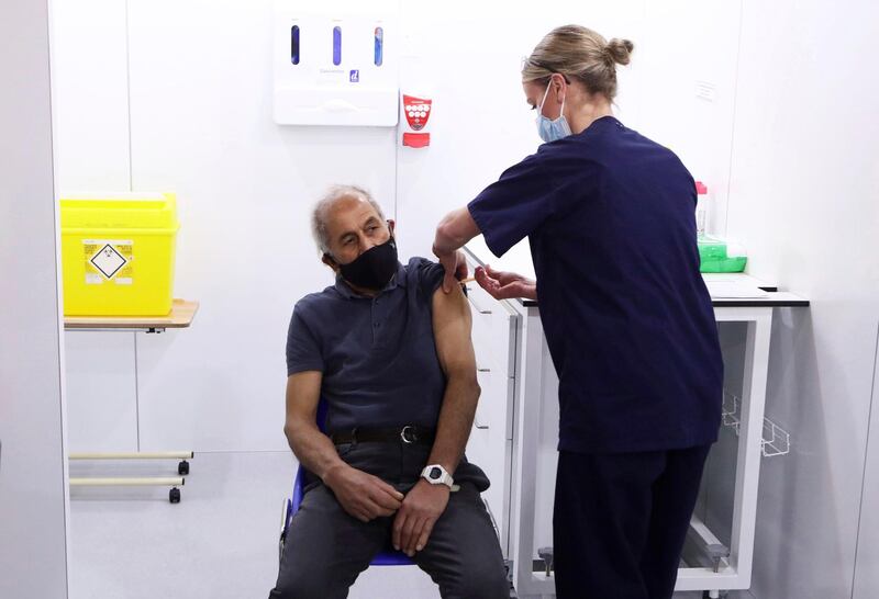 Olivia Smart, advanced practitioner, vaccinates Mewa Singh Khela, 72, with his first dose of the Oxford AstraZeneca coronavirus vaccine at the Elland Road vaccination centre in Leeds. AP Photo