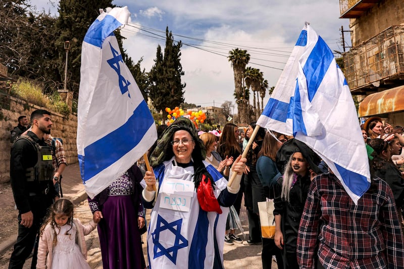 Orit Malka Strock, Israel's Minister of Settlements and National Missions, centre, stands with settlers in the divided West Bank city of Hebron on Sunday. The settler movement has moved from the fringes of Israeli politics to the heart of government. AFP