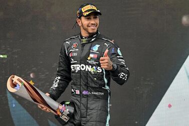 Winner Mercedes' British driver Lewis Hamilton (C) celebrates with the trophy on the podium after the Turkish Formula One Grand Prix at the Intercity Istanbul Park circuit in Istanbul on November 15, 2020. (Photo by OZAN KOSE / POOL / AFP)