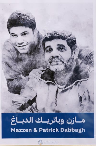 A poster featuring Mazen and Patrick Dabbagh at a stand near the Paris court. EPA
