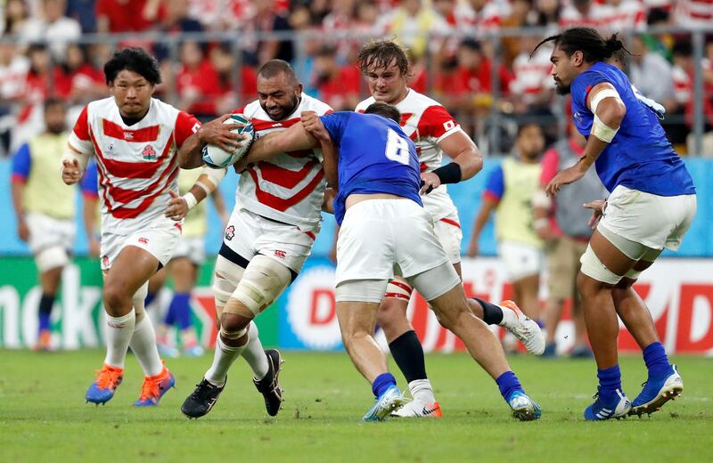 Japan's Michael Leitch runs at Samoa's Jack Lam during the Rugby World Cup Pool A match. Associated Press