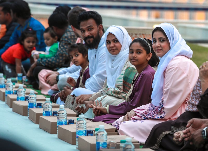 Worshippers wait for the start of iftar at the mosque. Victor Besa / The National