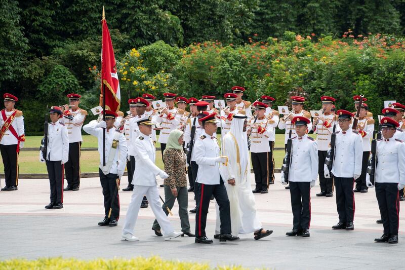 SINGAPORE, SINGAPORE - February 28, 2019: HH Sheikh Mohamed bin Zayed Al Nahyan, Crown Prince of Abu Dhabi and Deputy Supreme Commander of the UAE Armed Forces (4th R) and HE Halimah Yacob, President of Singapore (6th R), inspect the honor guard during a reception, at the Istana presidential palace.
( Mohamed Al Hammadi / Ministry of Presidential Affairs )
—