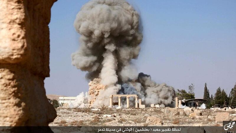 An undated image, which appears to be a screenshot from a video and which was published by the Islamic State group in the Homs province (Welayat Homs) on August 25, 2015, allegedly shows smoke billowing from the Baal Shamin temple in Syria's ancient city of Palmyra. The temple was reportedly destroyed by the extremist group and news of its demolition sparked international condemnation earlier this week. AFP PHOTO / HO / WELAYAT HOMS 
=== RESTRICTED TO EDITORIAL USE - MANDATORY CREDIT "AFP PHOTO / HO / WELAYAT HOMS" - NO MARKETING NO ADVERTISING CAMPAIGNS - DISTRIBUTED AS A SERVICE TO CLIENTS FROM ALTERNATIVE SOURCES, AFP IS NOT RESPONSIBLE FOR ANY DIGITAL ALTERATIONS TO THE PICTURE'S EDITORIAL CONTENT, DATE AND LOCATION WHICH CANNOT BE INDEPENDENTLY VERIFIED === (Photo by - / WELAYAT HOMS / AFP)