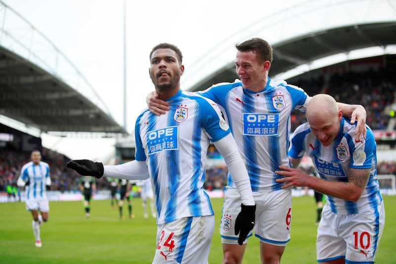 Soccer Football - Premier League - Huddersfield Town vs AFC Bournemouth - John Smith’s Stadium, Huddersfield, Britain - February 11, 2018   Huddersfield Town’s Steve Mounie celebrates scoring their third goal with Jonathan Hogg and Aaron Mooy    Action Images via Reuters/Jason Cairnduff    EDITORIAL USE ONLY. No use with unauthorized audio, video, data, fixture lists, club/league logos or "live" services. Online in-match use limited to 75 images, no video emulation. No use in betting, games or single club/league/player publications.  Please contact your account representative for further details.