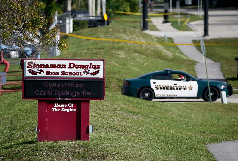 Law enforcement officers block off the entrance to Marjory Stoneman Douglas High School on February 15, 2018 in Parkland, Florida, following a deadly shooting at the school. AP