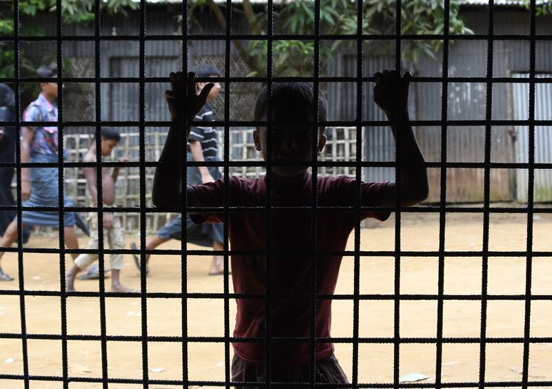 A young Rohingya Muslim refugee waits outside the World Food Programme office in Ukhia, Bangladesh. Dominique Faget / AFP Photo