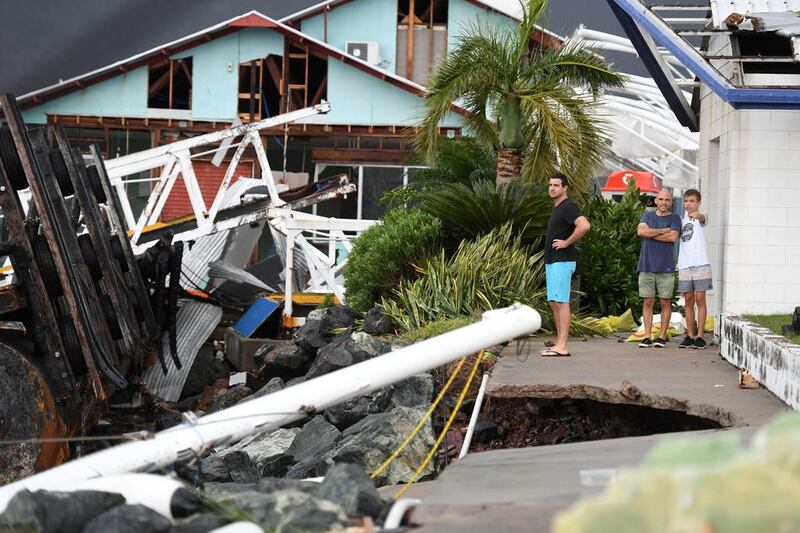 Locals inspecting the damage to the marina at Shute Harbour near Airlie Beach, Queensland. Emergency crews also began assessing the damage but blocked roads and flash flooding hampered effort. Dan Paled/EPA