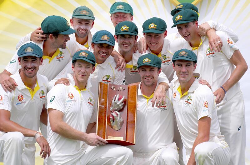 epa07341845 Australia's captain Tim Paine holds the trophy as he poses with team mates after they won the series after day four of the second Test match between Australia and Sri Lanka at Manuka Oval in Canberra, Australia, 04 February 2019.  EPA/DAVID GRAY NO ARCHIVING, EDITORIAL USE ONLY, IMAGES TO BE USED FOR NEWS REPORTING PURPOSES ONLY, NO COMMERCIAL USE WHATSOEVER, NO USE IN BOOKS WITHOUT PRIOR WRITTEN CONSENT FROM AAP AUSTRALIA AND NEW ZEALAND OUT