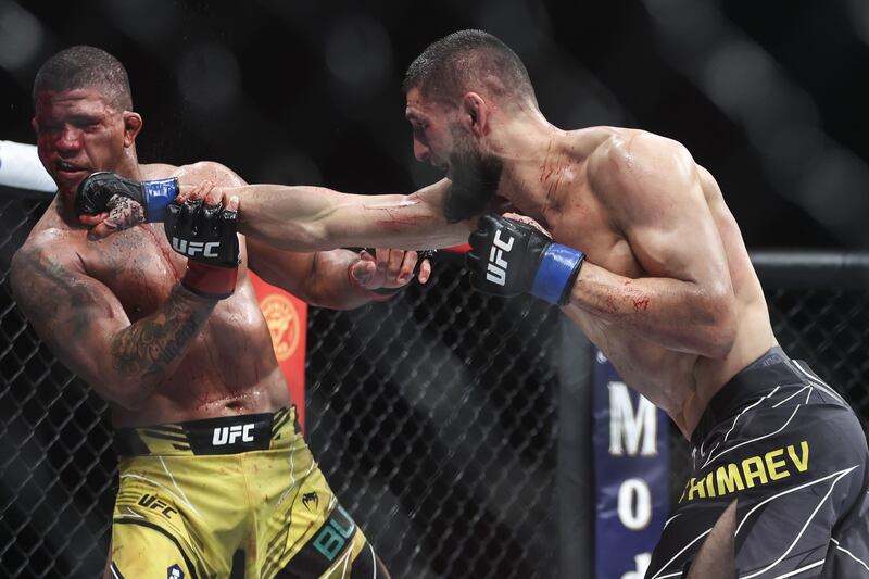 Khamzat Chimaev punches Gilbert Burns during their welterweight bout at UFC 273. Getty
