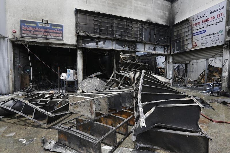 Four workshops are damaged by a fire in Umm Ramool industrial area in Dubai. Jeffrey E Biteng / The National 