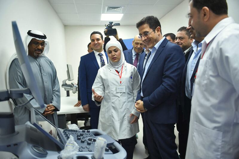 Syrian Minister of Health Hassan Al Ghabbash, centre right, and Emirati charge d'affaires Abdul Hakeem Al Nuaimi, left, listen to a doctor during the opening ceremony of the UAE-funded Sheikh Mohamed bin Zayed Field Hospital in Aleppo. AFP