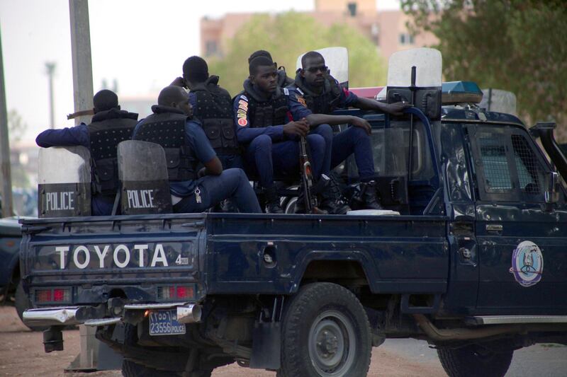 Police officers stand gaurd outside the courthouse, where former Sudanese president Omar al-Bashir and more than 20 others are tried for their role in the 1989 military takeover of the government, Khartoum, Sudan.  EPA