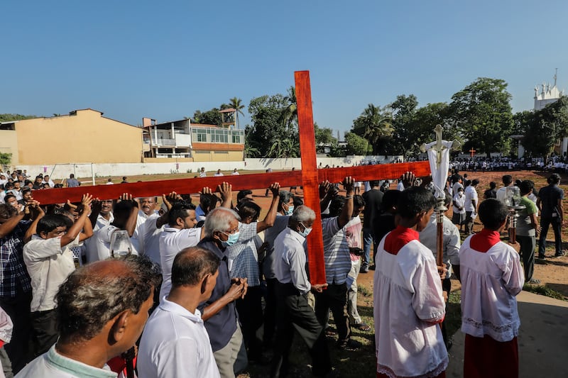 Roman Catholics carry a cross during the Good Friday procession at St Francis De Sales church in the Dalugama suburb of Colombo, Sri Lanka. EPA