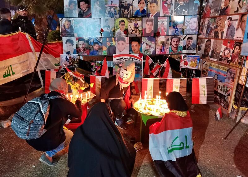 People light candles for slain protesters in Tahrir Square, in Baghdad. AP