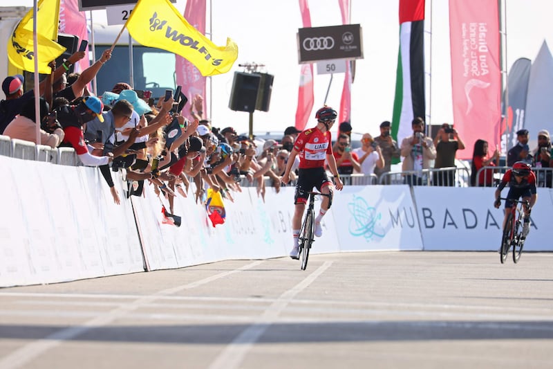 UAE Team Emirates' Tadej Pogacar celebrates as he crosses the finish line to win the UAE Tour. AFP