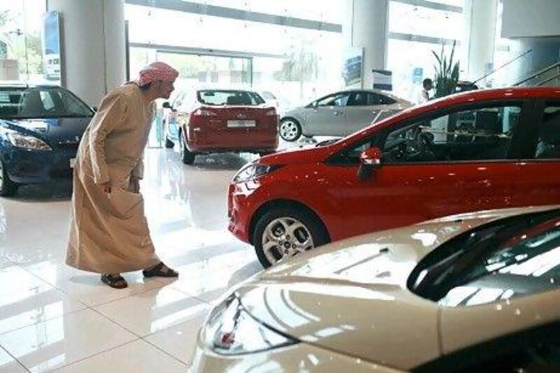 A Ford Fiesta comes under scrutiny in Premier Motors' Abu Dhabi showroom. The American car manufacturer is forecasting sales in the UAE to top 13,500 this year. Philip Cheung / The National