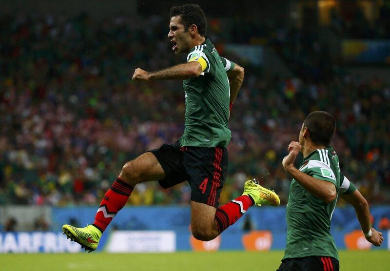 Rafael Marquez celebrates his goal against Croatia on Monday as Javier Hernandez looks on at the 2014 World Cup in Recife, Brazil. Paul Hanna / Reuters / June 23, 2014