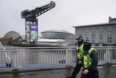 Police officers walk by the Scottish Event Campus in Glasgow where Cop26 is being held. PA