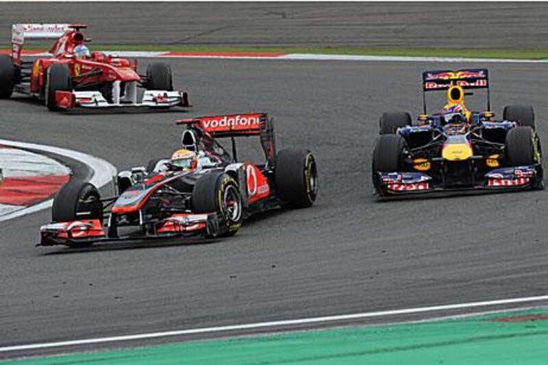 Lewis Hamilton, centre, held off the challenge of Fernando Alonso, left, and Mark Webber to win the German Grand Prix.