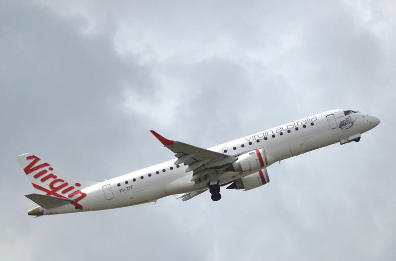 This photo taken on August 28, 2014 shows a Virgin Australia plane taking off at Sydney Airport in Sydney. Virgin Australia posted an annual net loss of 332 million USD as intense competition led by Qantas, weak consumer sentiment and high taxes hurt its bottom line. AFP PHOTO / Peter PARKS (Photo by PETER PARKS / AFP)