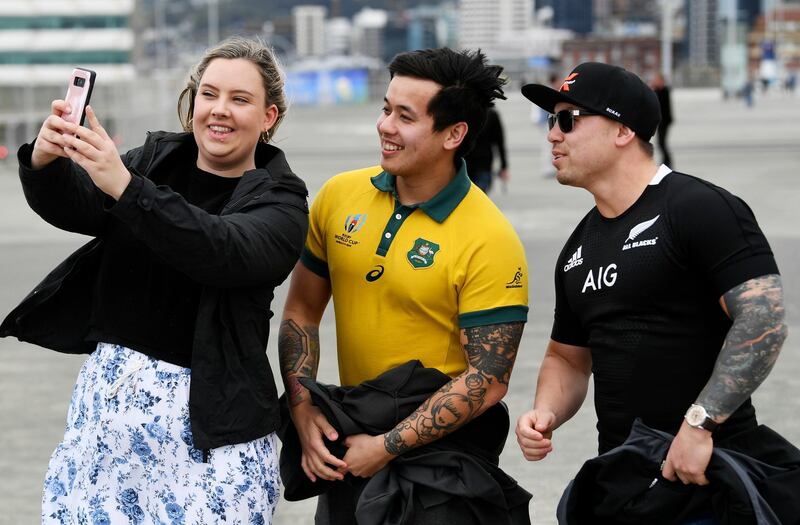 Fans take a selfie as they arrive at the stadium ahead of during the Bledisloe Cup rugby game between the All Blacks and the Wallabies in Wellington, New Zealand. AP Photo