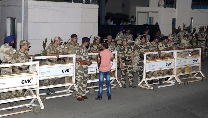Indian security personnel stand guard outside the airport as the family of late Indian actress Sridevi Kapoor arrive with her mortal remains in Mumbai, India. Divyakant Solanki / EPA
