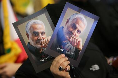 A supporter of Lebanon's Hezbollah leader Hassan Nasrallah carries pictures of the late Iran's Quds Force top commander Qassem Suleimani during a rally commemorating the Hezbollah's slain leaders, in Beirut's southern suburbs, Lebanon. Reuters