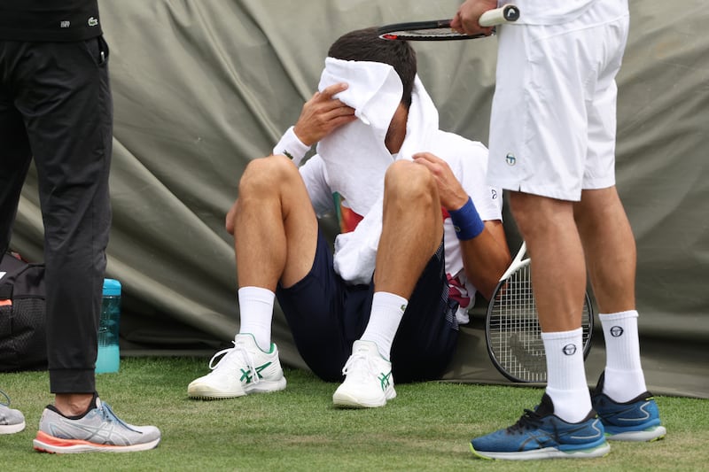 Novak Djokovic takes a break during training. Getty