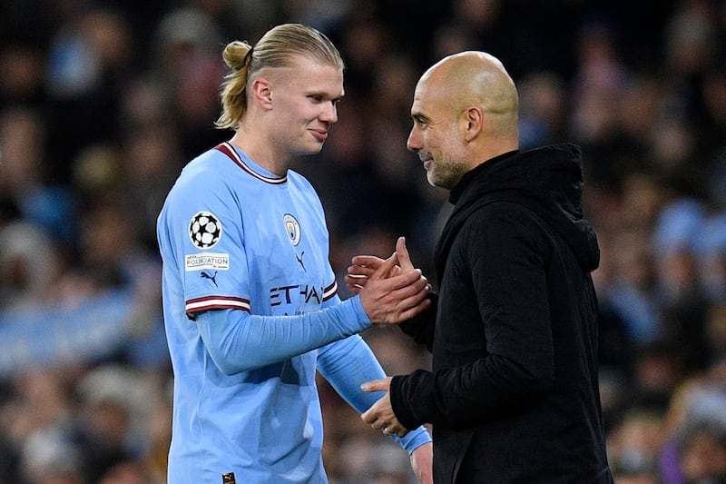 Erling Haaland shakes hands with Pep Guardiola after being substituted off during Manchester City's Champions League victory against RB Leipzig. AFP