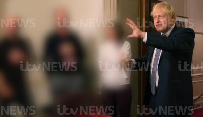 One of the photographs showing Prime Minister Boris Johnson raising a glass at a leaving party. PA / ITN