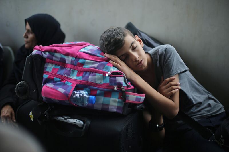 A Palestinian boy sleeps as he waits with his family for a travel permit to cross into Egypt through the Rafah border crossing after it was opened by Egyptian authorities for humanitarian cases, in Rafah in the southern Gaza Strip August 16, 2017. Ibraheem Abu Mustafa / Reuters