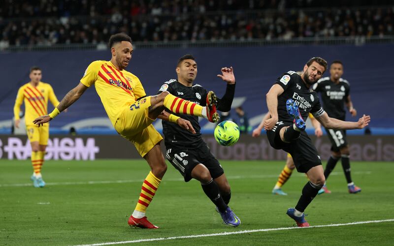 Pierre-Emerick Aubameyang battles for possession with Casemiro of Real Madrid. Getty Images