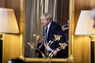 LONDON, ENGLAND - AUGUST 30: British Prime Minister Boris Johnson is reflected in a mirror as he arrives to take questions from young people aged between 9-14 to coincide with an education announcement at 10 Downing Street on August 30, 2019 in London, England. (Photo by Jeremy Selwyn - WPA Pool/Getty Images)