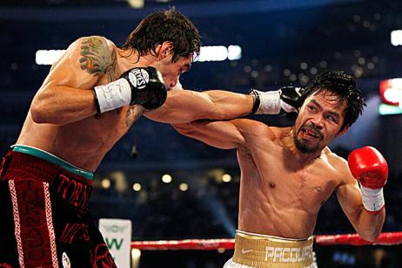 Manny Pacquiao, right, was in brutal mood at Cowboys Stadium against Antonio Margarito as he won the fight on all three judges’ scorecards 120-109, 119-109 and 118-110.