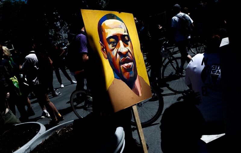 A person holds a parting of George Floyd at the steps of Brooklyn Borough Hall during a Black Lives Matter protest in Brooklyn, New York.  EPA