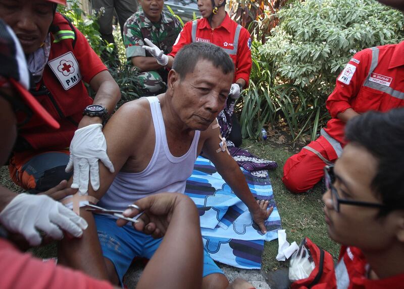 Paramedics tend to a man injured in a church explosion in Surabaya, East Java, Indonesia. Almost simultaneous attacks including one by a suicide bomber disguised as a churchgoer targeted churches in Indonesia's second largest city of Surabaya early Sunday, killing a number of people and wounding dozens, police said. Trisnadi / AP Photo