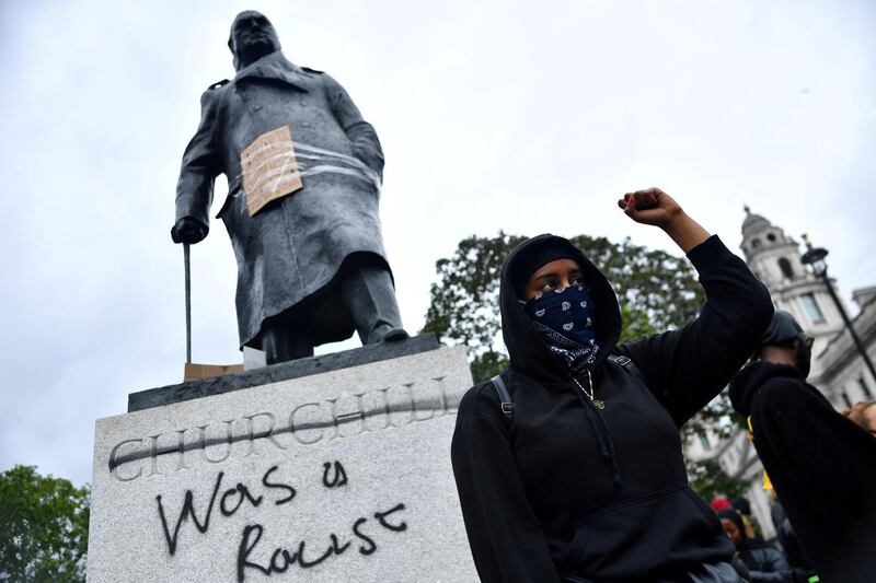 FILE PHOTO: A demonstrator reacts infront of graffiti on a statue of Winston Churchill in Parliament Square during a Black Lives Matter protest in London, following the death of George Floyd who died in police custody in Minneapolis, London, Britain, June 7, 2020. REUTERS/Dylan Martinez     TPX IMAGES OF THE DAY - RC2G4H9061BN/File Photo