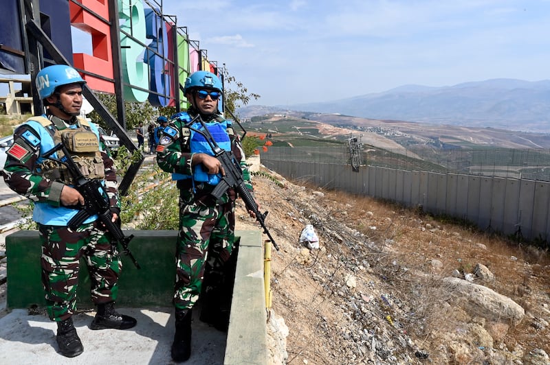 Members of the UN peacekeeping mission UNIFIL keep watch on the Israeli town of Misgav Am from Aadaysit in southern Lebanon. EPA