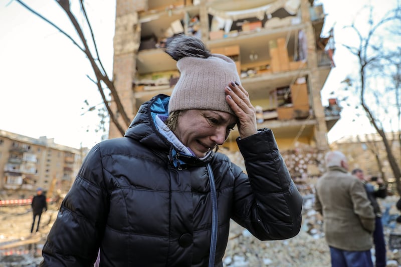 A woman cries near a building damaged by shelling in Kyiv as Russia's attack on Ukraine continues. EPA