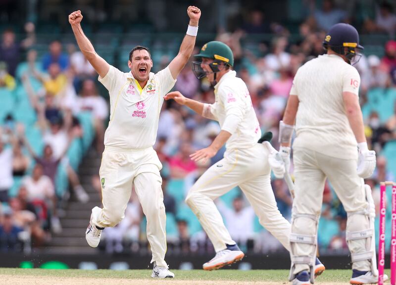 Australia's Scott Boland (L) celebrates with team mate Marnus Labuschagne (C) after they dismissed EnglandÕs Jonny Bairstow (R) on day five of the fourth Ashes cricket test between Australia and England at the Sydney Cricket Ground (SCG) on January 9, 2022.  (Photo by DAVID GRAY  /  AFP)