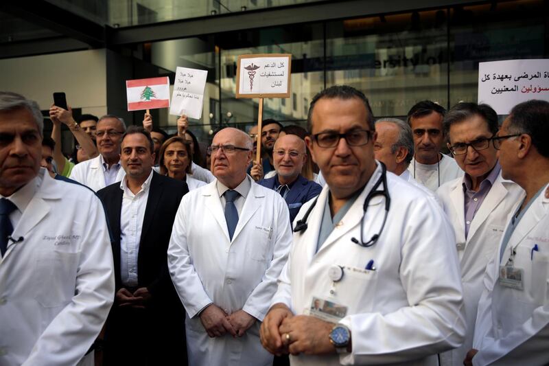 Medical personnel stand during a protest at the American University of Beirut Medical Center in Beirut, Lebanon. Reuters