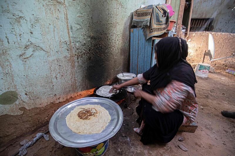 Umm Abdo prepares bread for the family in her home on the west bank of the Nile, by Egypt's southern city of Aswan. All photos: AFP