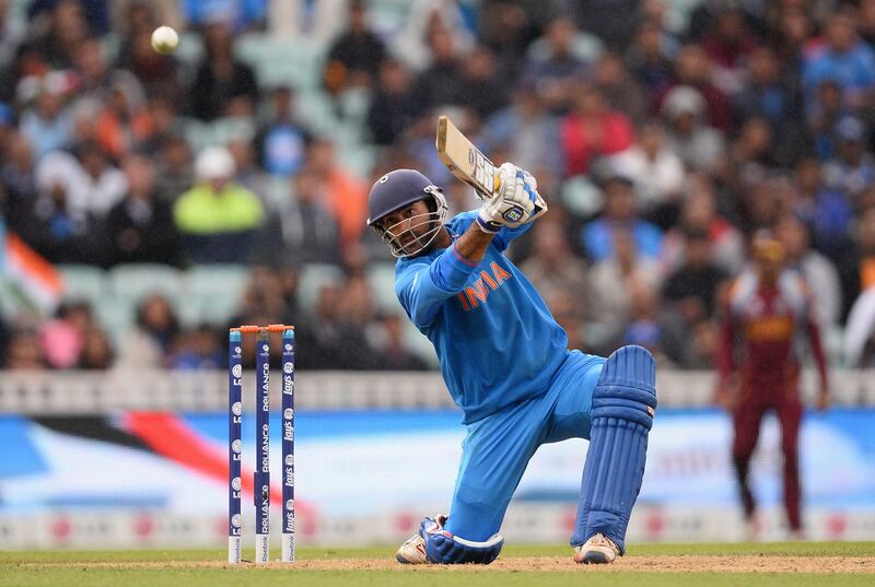 LONDON, ENGLAND - JUNE 11:  Dinesh Karthik of India smashes a boundary to reach his half centurynand win the match during the ICC Champions Trophy Group B match between India and West Indies  at The Kia Oval on June 11, 2013 in London, England.  (Photo by Mike Hewitt/Getty Images) *** Local Caption ***  170334755.jpg