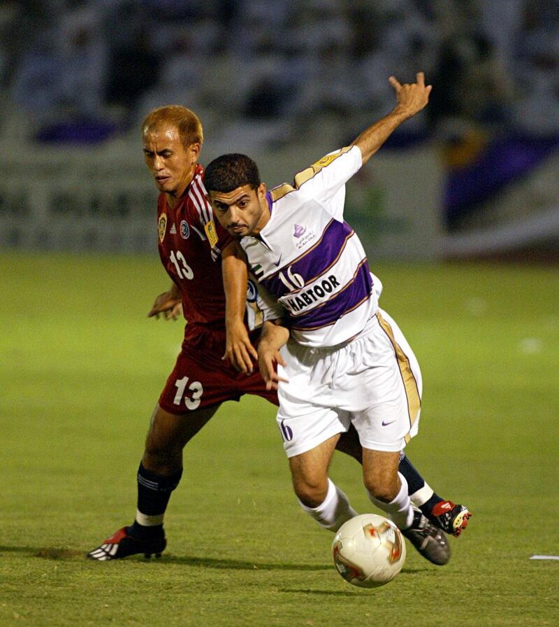 Emirati player Abdullah Ali Mosabbah (R) of Emirati Al-Ain club, fights for the ball with Thai player Therdsak Chaiman (L) of Thai Tero Sasana club during their AFC Champions League final in Al-Ain 03 October 2003. AFP PHOTO/Rabih MOGHRABI (Photo by RABIH MOGHRABI / AFP)