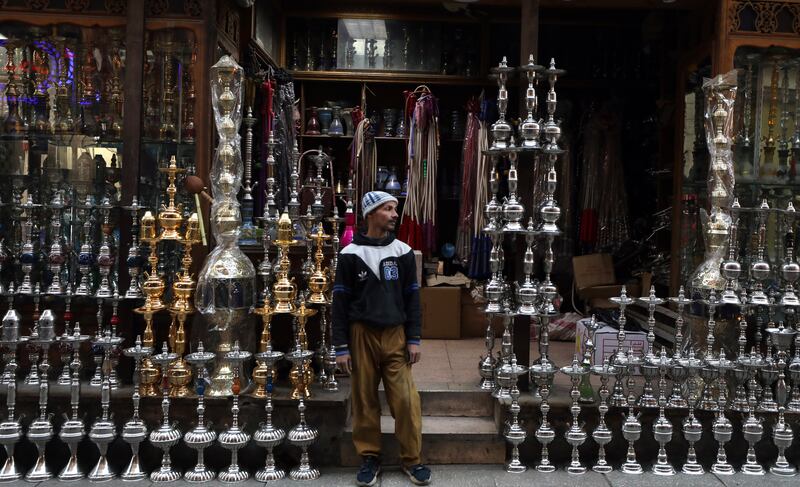 Egyptian worker sells shisha water pipe in the historical street of Elmoez Lideen Ella in Old Cairo ,Egypt, 11 January 2023.  The complex of Sultan Qalawun was built along the Shari' el-Moez (street) in 1284 by Sultan al-Mansur Qalawun.  It is comprised of a mosque-medersa, a mausoleum and a mauristan (which was replaced by a modern hospital in the 1920s)  EPA / KHALED ELFIQI