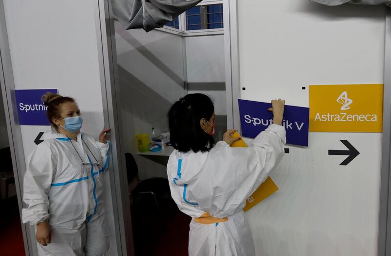 A medical worker sets up boards with the names of the vaccines at a vaccination centre in Belgrade. Serbia has vaccinated most people with China's Sinopharm, followed by Pfizer, Russia's Sputnik V and recently the AstraZeneca shot. AP