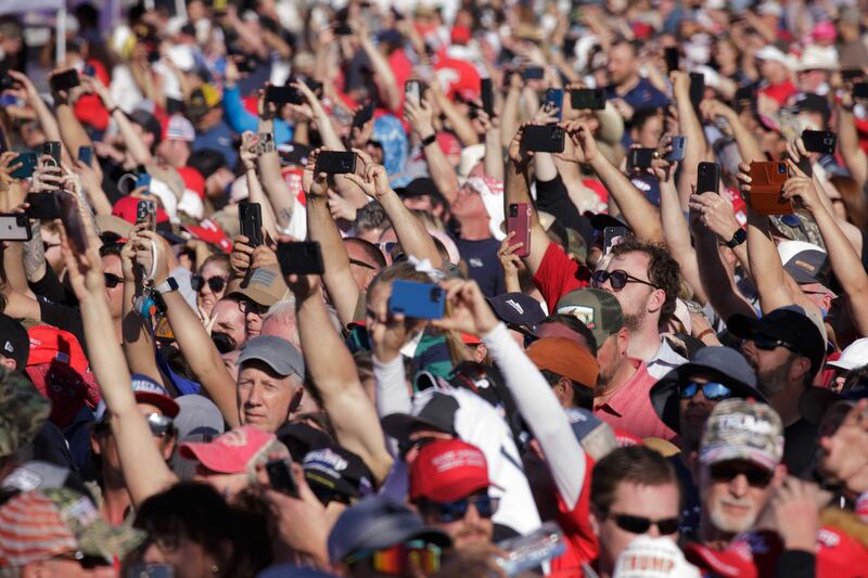 Trump supporters take videos of his speech. AFP